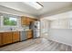 Open kitchen with stainless steel refrigerator, modern flooring, and view to adjacent room at 9214 Winona Ct, Westminster, CO 80031