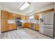 A well-lit kitchen featuring wooden cabinets, stainless steel appliances, and modern countertops at 9214 Winona Ct, Westminster, CO 80031