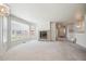 Open-concept living room with large windows and a charming brick fireplace at 9214 Winona Ct, Westminster, CO 80031