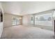 Sun-filled living room with a fireplace, large window, and sliding glass door at 9214 Winona Ct, Westminster, CO 80031