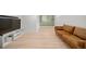 Spacious basement with updated flooring, large television, and comfortable seating area at 1401 Ash St, Denver, CO 80220