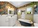 Charming bathroom featuring floral wallpaper, a clawfoot tub, and vintage-inspired design elements at 1401 Ash St, Denver, CO 80220