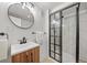 A renovated bathroom with a stylish vanity and a modern, glass-enclosed shower at 1401 Ash St, Denver, CO 80220