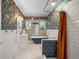 Stylish bathroom featuring floral wallpaper, clawfoot tub, brass fixtures, and elegant design at 1401 Ash St, Denver, CO 80220