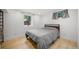 A cozy bedroom with light wood floors and a large window at 1401 Ash St, Denver, CO 80220