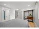 A light-filled bedroom with storage shelf and easy access to the bathroom at 1401 Ash St, Denver, CO 80220