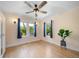 Light and airy bedroom featuring hardwood floors, large windows, and classic ceiling fan at 1401 Ash St, Denver, CO 80220
