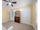 Bedroom with ceiling fan, carpet, and a built-in bookshelf and closet at 1401 Ash St, Denver, CO 80220
