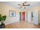 Bright bedroom with hardwood floors, ceiling fan, wardrobe and closet with modern art at 1401 Ash St, Denver, CO 80220