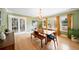 Open dining room with a chandelier, hardwood floors, and large windows that allow natural light at 1401 Ash St, Denver, CO 80220