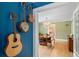 View of the dining room with view to table and chairs; musical instruments on wall at 1401 Ash St, Denver, CO 80220