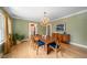 Dining room with a large wooden table, blue chairs, chandelier, and green walls at 1401 Ash St, Denver, CO 80220