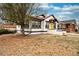 Charming bungalow featuring a bright yellow front door, contrasted by black trim and a classic design at 1401 Ash St, Denver, CO 80220