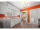 Bright kitchen featuring stainless steel appliances, white cabinets, and an adjacent breakfast nook at 1401 Ash St, Denver, CO 80220