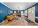 Stylish living room featuring blue walls, a decorative fireplace, built-in shelving, and hardwood floors at 1401 Ash St, Denver, CO 80220
