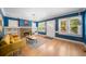 Bright living room featuring hardwood floors, a cozy fireplace, and abundant natural light at 1401 Ash St, Denver, CO 80220