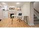 Basement office with fireplace, glass desk, hardwood floors and natural light at 1265 Saint Paul St, Denver, CO 80206