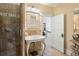 Bathroom with tan tiled shower and walls featuring a vintage sink at 1265 Saint Paul St, Denver, CO 80206