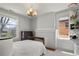 Charming bedroom featuring a decorative chandelier, fireplace and sun-filled windows at 1265 Saint Paul St, Denver, CO 80206