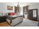 Bedroom with neutral tones, a comfortable bed, and a stylish dresser at 1265 Saint Paul St, Denver, CO 80206