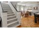 View of the dining room from the stairway showing hardwood floors and the built-in bar at 1265 Saint Paul St, Denver, CO 80206