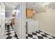 Basement hallway with laundry room and full bathroom with clawfoot tub at 1265 Saint Paul St, Denver, CO 80206