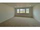 Cozy bedroom with plush carpeting and three windows offering natural light and neighborhood views at 767 Raindance St, Erie, CO 80516