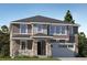 Charming two-story home featuring a stone-accented porch and attached garage at 767 Raindance St, Erie, CO 80516