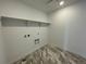 Utility room with tile flooring, a shelf, and laundry hookups at 767 Raindance St, Erie, CO 80516