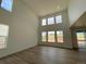 Bright living room featuring high ceilings, large windows, and wood flooring at 767 Raindance St, Erie, CO 80516