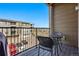 Cozy balcony with a table and chairs overlooking the parking area at 480 E Fremont Pl # 308, Centennial, CO 80122