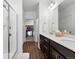 Bright bathroom featuring a glass shower, dual sink vanity, and walk-in closet at 480 E Fremont Pl # 308, Centennial, CO 80122