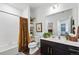 Clean bathroom with a shower-tub combo, elegant vanity, and decorative shelving at 480 E Fremont Pl # 308, Centennial, CO 80122