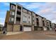 Modern apartment building with brick and siding and attached garages at 480 E Fremont Pl # 308, Centennial, CO 80122
