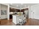 Well-lit kitchen featuring granite countertops, stainless steel appliances, dark cabinets, and breakfast bar at 480 E Fremont Pl # 308, Centennial, CO 80122