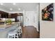 Modern kitchen with granite countertops, stainless steel appliances, and dark wood cabinets at 480 E Fremont Pl # 308, Centennial, CO 80122