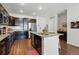 Stylish kitchen with granite countertops, stainless steel appliances, dark cabinets, and breakfast bar at 480 E Fremont Pl # 308, Centennial, CO 80122