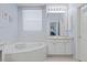 Bathroom with a soaking tub, vanity, and tiled floor at 329 Bobcat Pt, Lafayette, CO 80026