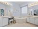 Spacious bathroom features a whirlpool tub, dual vanity, and tile flooring at 329 Bobcat Pt, Lafayette, CO 80026