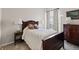 Cozy bedroom with a queen-sized bed, floral drapes, and bedside lamps at 329 Bobcat Pt, Lafayette, CO 80026