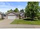 Charming brick home with a two-car garage, well-kept lawn, and a mature tree at 329 Bobcat Pt, Lafayette, CO 80026