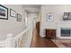 Upstairs hallway shows wood floors, a fireplace in view, and white trim at 329 Bobcat Pt, Lafayette, CO 80026
