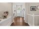 Hallway with hardwood floors and decorative accents leading to various rooms at 329 Bobcat Pt, Lafayette, CO 80026