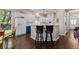 Open kitchen area with bar seating, modern appliances, and dark wood flooring at 329 Bobcat Pt, Lafayette, CO 80026