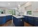 Spacious kitchen with blue cabinets, white countertops, and stainless steel appliances at 329 Bobcat Pt, Lafayette, CO 80026