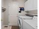 Neat laundry room features a washer, dryer, and storage cabinets at 329 Bobcat Pt, Lafayette, CO 80026