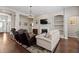 Comfortable living room features a fireplace, built-in shelving, and hardwood flooring at 329 Bobcat Pt, Lafayette, CO 80026