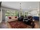 Cozy living room with large windows and an open layout connecting to the kitchen at 329 Bobcat Pt, Lafayette, CO 80026