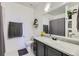 Bright bathroom featuring gray vanity, granite counters, and a large mirror, creating a fresh and modern feel at 4100 Albion St # 221, Denver, CO 80216