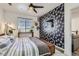 Cozy bedroom with feature wall, ceiling fan, and window with blinds at 4100 Albion St # 221, Denver, CO 80216